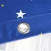 A close-up of a blue curtain with a star pattern and a grommet. Produktbild-Vorschau