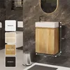A bathroom vanity with a sink and cabinet, shown against a dark tiled wall. Options for the cabinet finish are displayed on the left. Produktbild-Vorschau