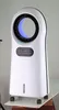A white air cooler with a blue light inside the fan grille, placed on a table with wheels. Produktbild-Vorschau