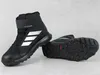 A pair of black Adidas Terrex winter boots are shown against a light gray background. One boot is standing upright, while the other is lying on its side, showing the sole. Náhled obrázku produktu