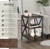 A side table with decorative items on it, next to a sofa. Produktbild-Vorschau
