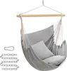 A gray hammock chair with two pillows, hanging from a wooden bar, with metal chains and a carabiner on the side. Náhled obrázku produktu