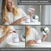 A woman demonstrating how to use an aromatherapy diffuser. Produktbild-Vorschau