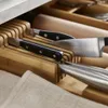 A close-up view of knives stored in a wooden drawer organizer. Náhled obrázku produktu