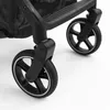 A close-up view of the wheels and frame of a stroller. Náhľad obrázku produktu