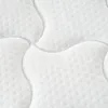 A close-up view of a white quilted mattress surface. Podgląd zdjęcia produktu