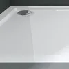 A close-up view of a white shower tray with a chrome drain. Produktbild-Vorschau