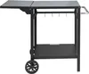 A black outdoor grill preparation cart with two shelves, a foldable side table, hooks for utensils, and wheels.
