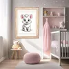 A nursery room with a framed picture of a cartoon animal, a crib, and decorative items. Produktbild-Vorschau