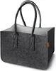 A dark gray felt shopping basket with orange tag on the side, shown against a white background. Produktbild-Vorschau