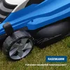 Close-up of a blue lawnmower wheel and body on grass. Produktbild-Vorschau