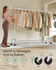 A woman is standing next to a clothes rack with clothes on it. The bottom part of the image shows close-ups of wheels and icons with text. Produktbild-Vorschau