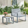 A grey outdoor chair and side table set are placed on a patio with plants in the background. Podgląd zdjęcia produktu