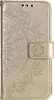A close-up, front-facing view of a gold flip phone case with a mandala embossed design. Produktbild-Vorschau