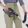 A person is holding a cordless string trimmer. Produktbild-Vorschau