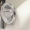 A close-up of a retro-style baby bouncer's headlight. Produktbild-Vorschau