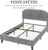 A grey upholstered bed frame with a tufted headboard, shown from a diagonal angle with the mattress slats visible. Produktbild-Vorschau