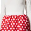 Close-up of a person wearing a white long-sleeved shirt and a red polka dot skirt. Produktbild-Vorschau