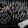 Outdoor Christmas lights in the shape of icicles hanging from trees in front of a house. Produktbild-Vorschau