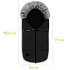 A black baby footmuff with a fur-lined hood is shown against a white background, with dimensions indicated by text. Náhled obrázku produktu