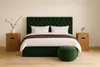 A bedroom scene with a bed, nightstands, and a pouf. Produktbild-Vorschau