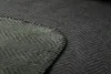 A close-up view of a dark gray herringbone patterned blanket, with a section of the blanket folded over to reveal a lighter green underside. The edges are stitched with dark thread. Produktbild-Vorschau
