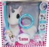 The image shows the packaging of a plush unicorn toy named Luna. The packaging features a clear window displaying the toy, along with promotional text and images of the toy's features. Voir les images du produit