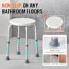 A white shower stool with gray rubber feet is shown in a bathroom setting, with text overlays highlighting its features. Podgląd zdjęcia produktu