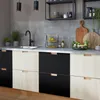 A modern kitchen with gray tiled backsplash and two-tone cabinets. Produktbild-Vorschau