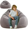 A young boy is sitting on a large beanbag chair, with another beanbag chair in the background. Produktbild-Vorschau