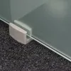 A close-up view of a frosted glass panel held by a light gray bracket, resting on a dark gray textured surface. Produktbild-Vorschau