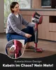 A woman is kneeling on the floor, demonstrating how to wind the cord onto a red stick vacuum cleaner. Produktbild-Vorschau
