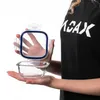 A person is holding a glass food storage container with its lid detached. Anteprima dell’immagine prodotto