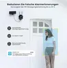 A security camera with a solar panel mounted on a white wall next to a door. A person is shown detected by the camera with a blue overlay. Produktbild-Vorschau