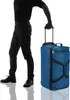 A person is holding the handle of a blue rolling duffel bag. Anteprima dell’immagine prodotto