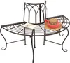 A metal garden bench with a curved seat and a backrest, placed on a white background. A straw hat with a pink scarf and a notebook are placed on the bench. Náhled obrázku produktu