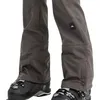 Close-up of the lower legs of a person wearing ski pants and ski boots. Produktbild-Vorschau