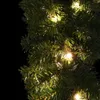 A close-up view of a green Christmas garland with small, warm white LED lights woven throughout. Produktbild-Vorschau