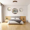A bedroom scene with a bed, nightstands, and decorative mirrors on the wall. Produktbild-Vorschau
