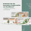 A collection of AuraNatura supplement boxes arranged on a white and green background with decorative leaf outlines. Náhled obrázku produktu