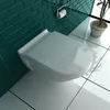 A modern bathroom setting with a white toilet and teal subway tile walls. Produktbild-Vorschau