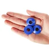 A hand holding three blue grommets. Produktbild-Vorschau