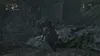 A character in a video game stands in a dark, rocky environment. Náhled obrázku produktu
