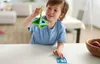 A young boy is holding a green geometric toy. Náhled obrázku produktu