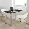 A small black table with two white chairs in a bright room with a window. Voir les images du produit