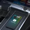 A smartphone displaying the CarPlay interface is placed on a wireless charging pad in a car's center console. Anteprima dell’immagine prodotto