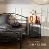 A bedroom scene with a bed, nightstand, and lamp. Náhled obrázku produktu