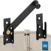 A black metal gate latch and catch are shown mounted on a beige gate. Náhled obrázku produktu