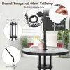 A round glass-top bistro table with a built-in umbrella hole, shown outdoors with two glasses of red wine and a vase of flowers. Podgląd zdjęcia produktu