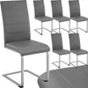 A set of four gray dining chairs with chrome legs are arranged on a white background. One chair is in the foreground, and three are in the background. Voir les images du produit
